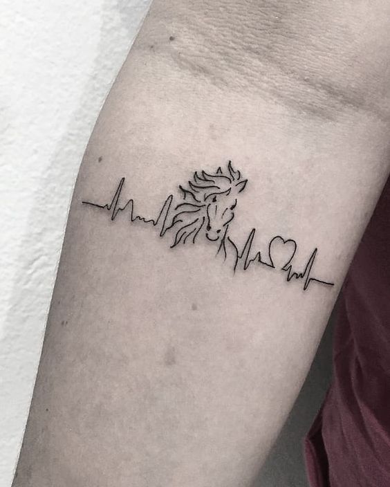 Heartbeat with horse tattoo on arm.