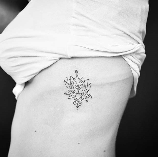 Impressive lotus tattoo on rib.