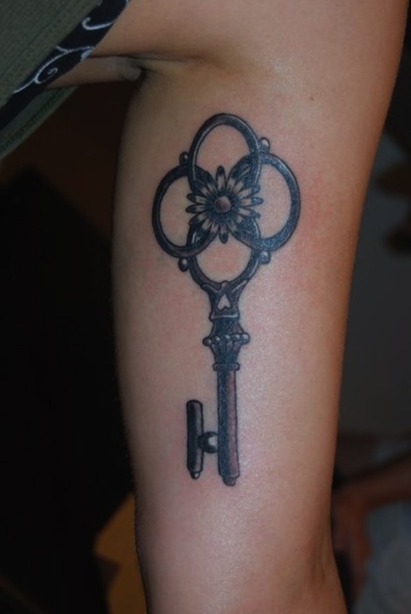 Inner arm key tattoo with sunflower.