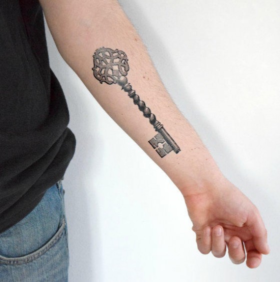Large skeleton key tattoo on forearm.