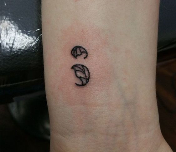 Leaf tattoo as semicolon.