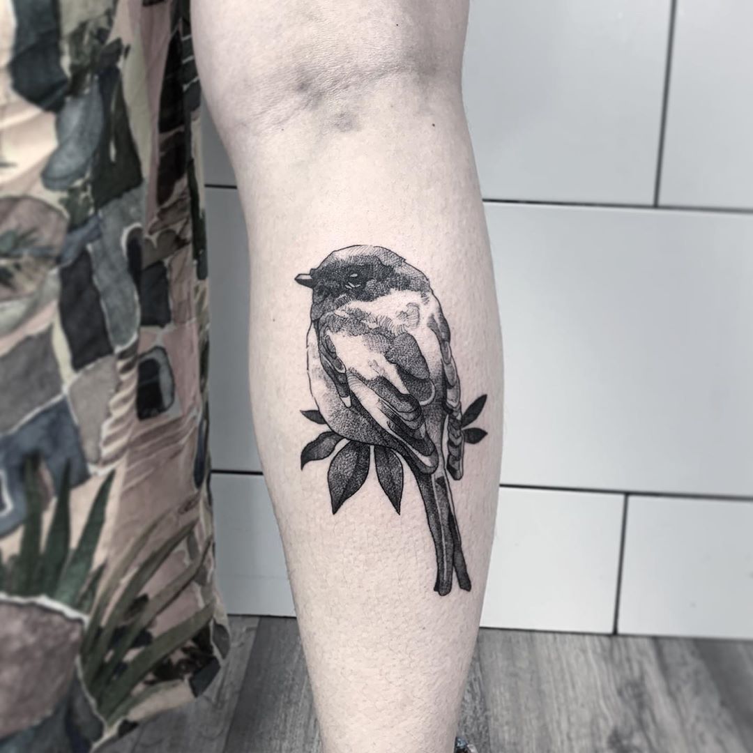 Line and dot work bird tattoo on hand.