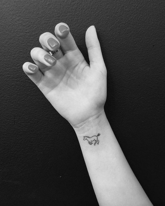Little horse tattoo on wrist.