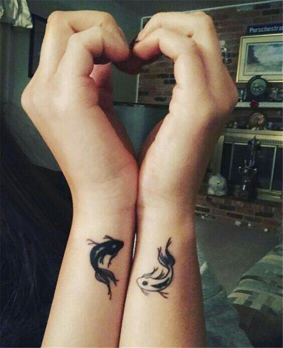 Matching fish tattoos for couple.