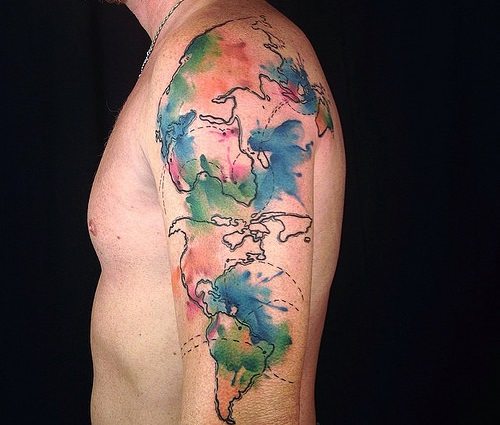 Running down watercolor world map tattoo on arm.