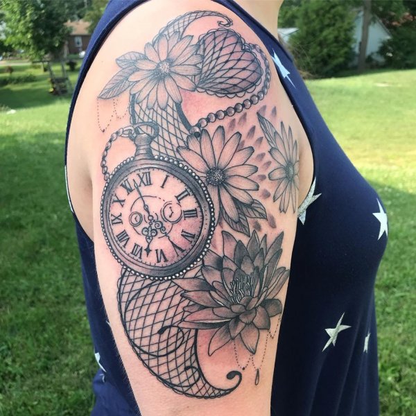 Sassy black and grey lace tattoo with pocket watch and flowers on shoulder.