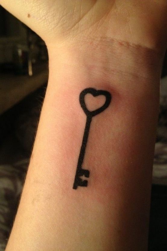 Simple black key tattoo for wrist.