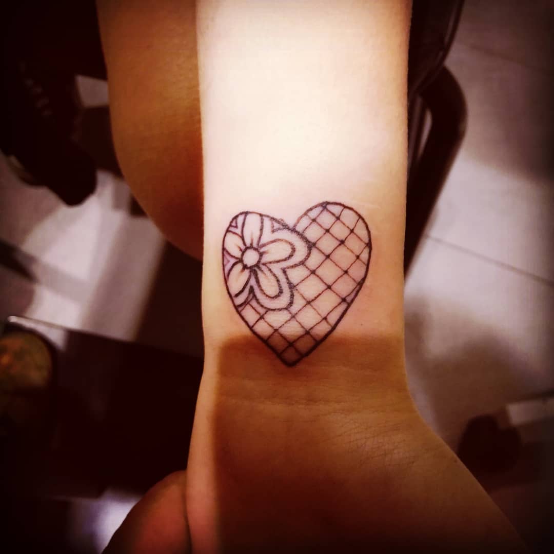 Simple lace heart tattoo for wrist.