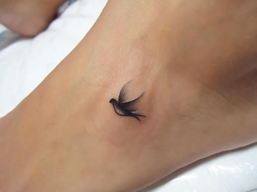 Single bird tattoo on foot.