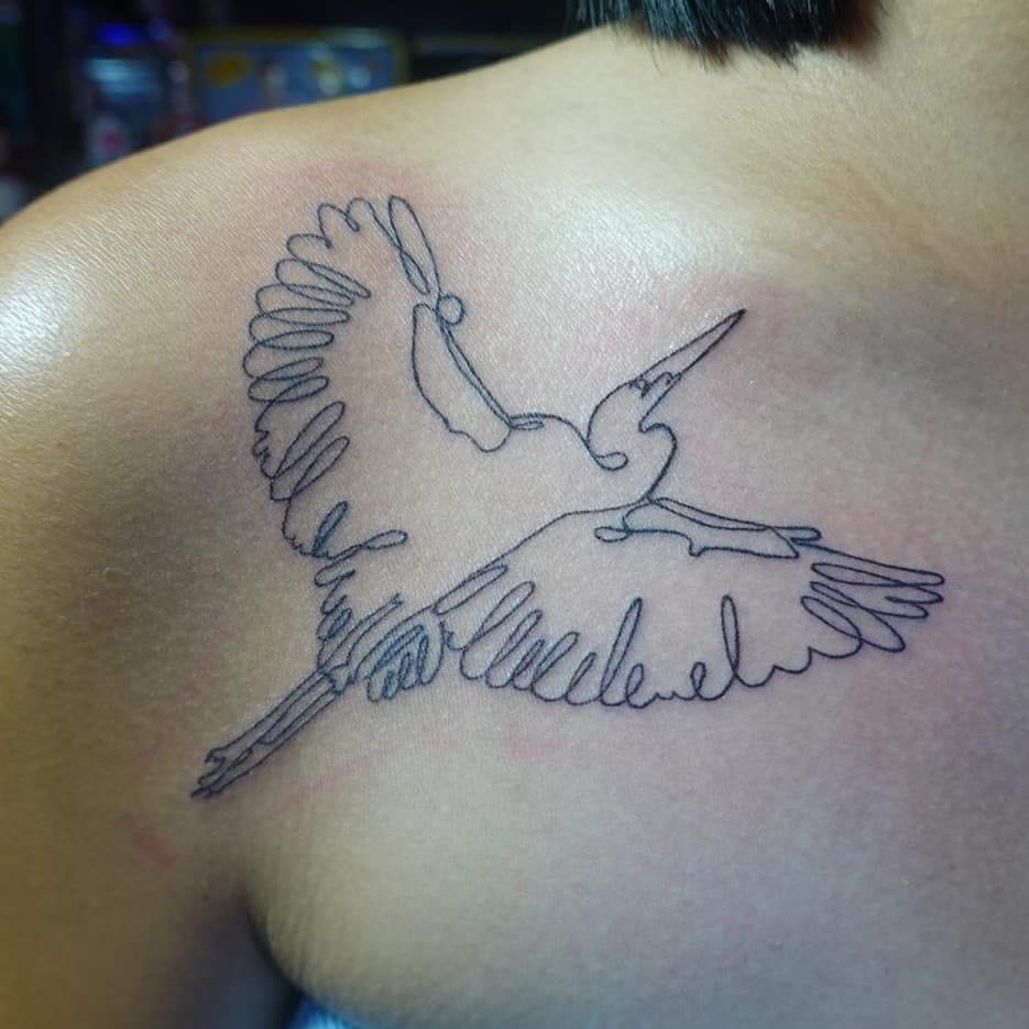 Single line bird tattoo on shoulder.