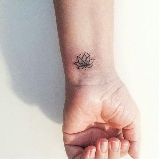 Small lotus wrist tattoo.