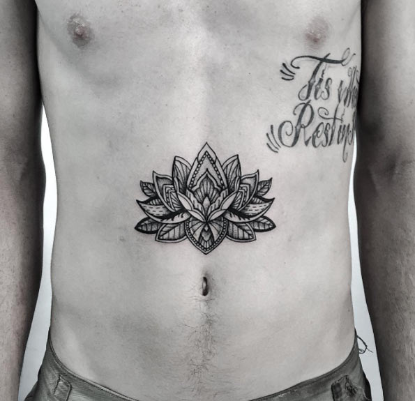 Stomach lotus flower tattoo for men.