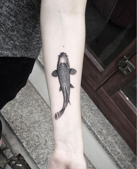 Stunning fish tattoo on inner arm.