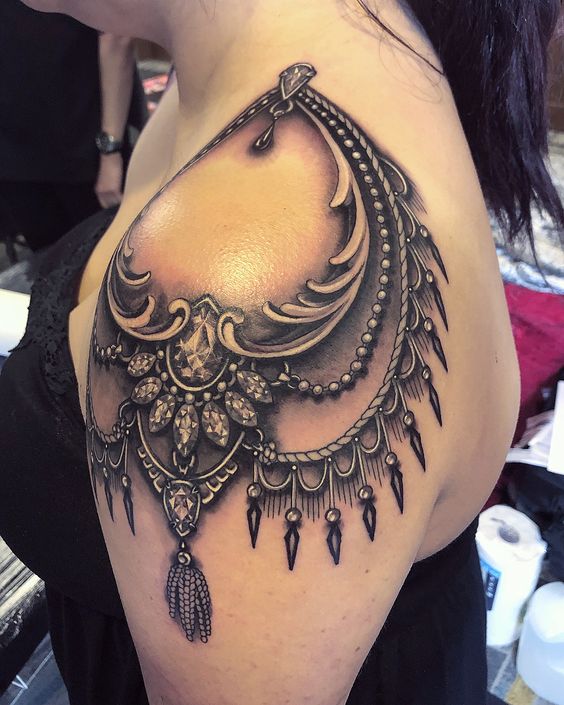 Stunning shoulder tattoo with lace design.