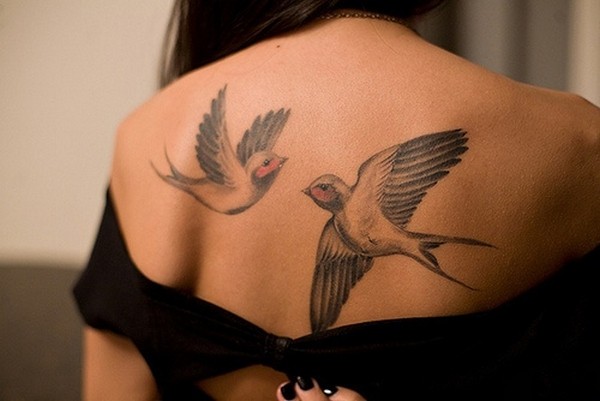 Swallow inked on back represents love and loyalty.