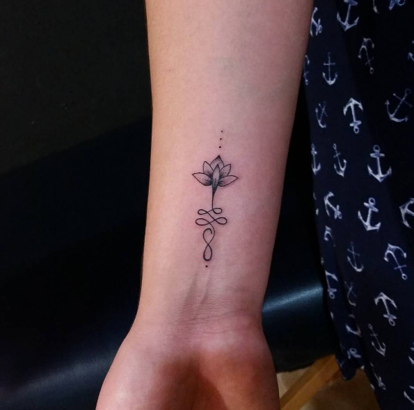 This small unalome lotus flower wrist tattoo.