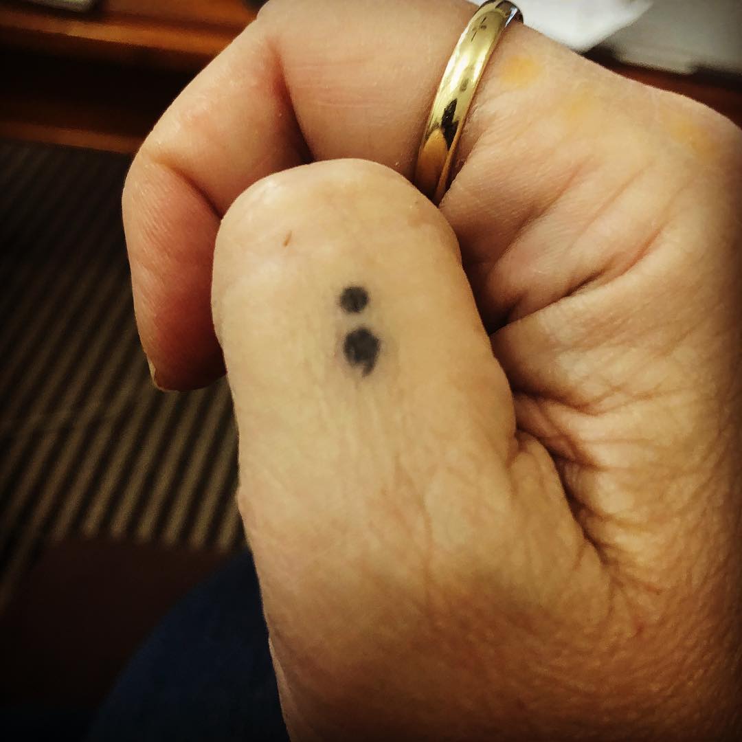 Thumb semicolon tattoo shows the power of wearer.