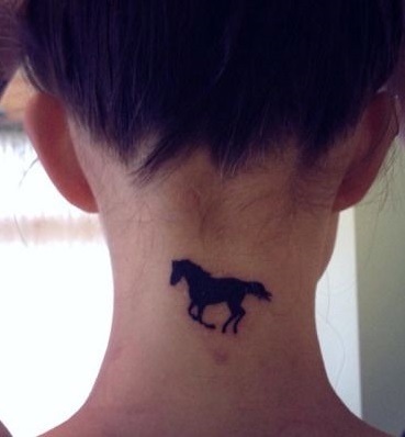 Tiny black horse tattoo for upper neck.