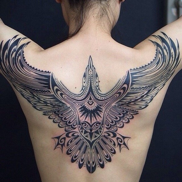 Tribal bird tattoo on back.