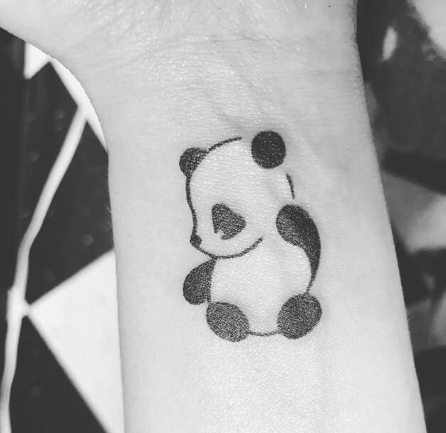 Ultimate wrist tattoo of a panda with the semicolon punctuation mark disguised as the ears and arm of the panda.
