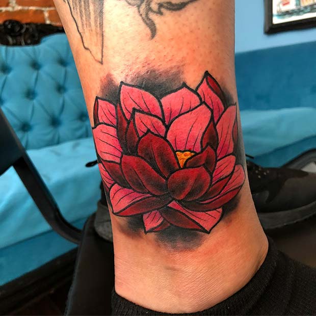 Vibrant 3D lotus flower tattoo for lower leg.
