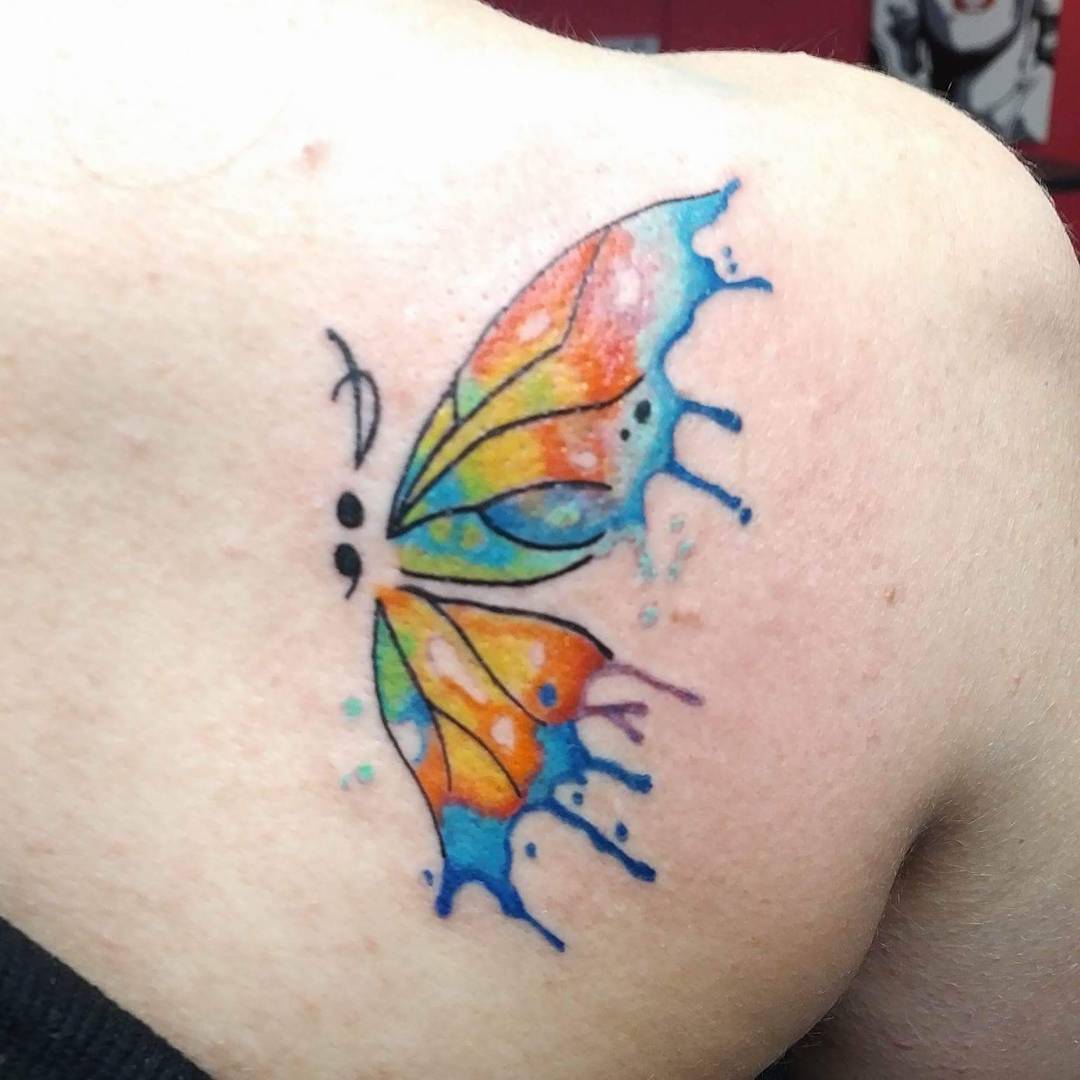 Watercolor semicolon butterfly on back shoulder.