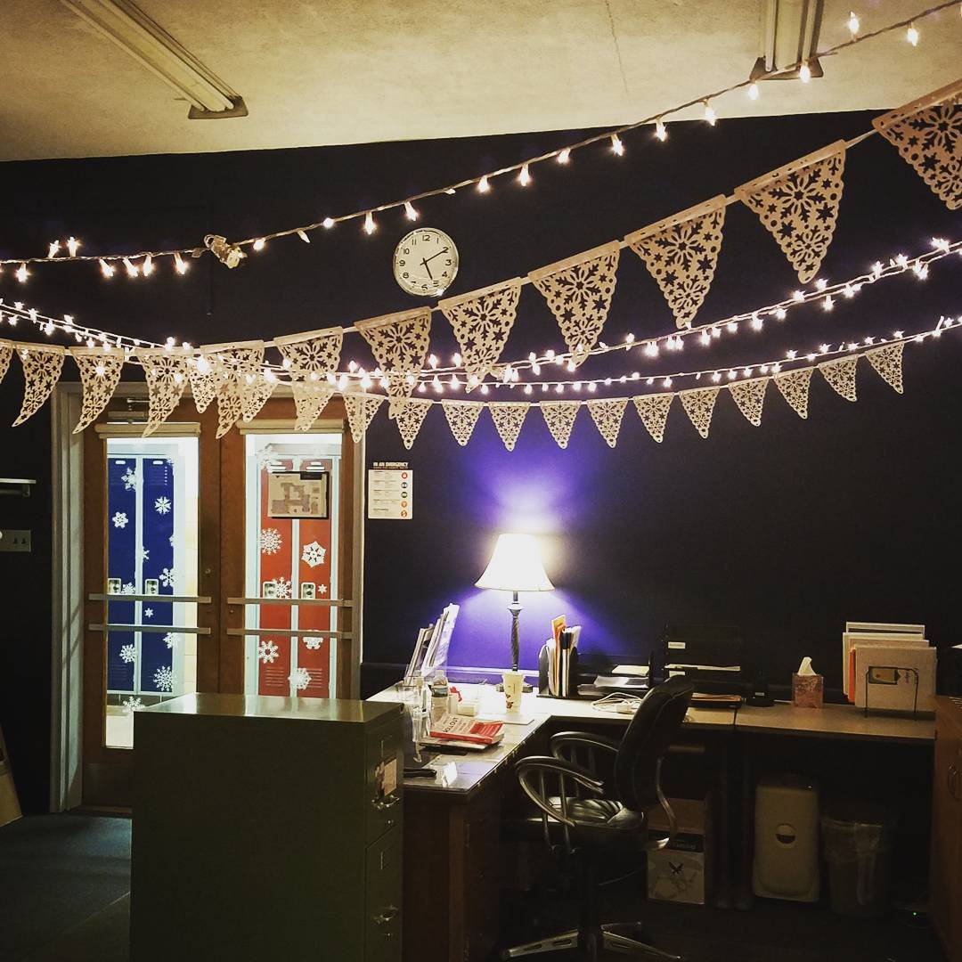 Beautiful snowflakes banner and fairy light decor at work place.