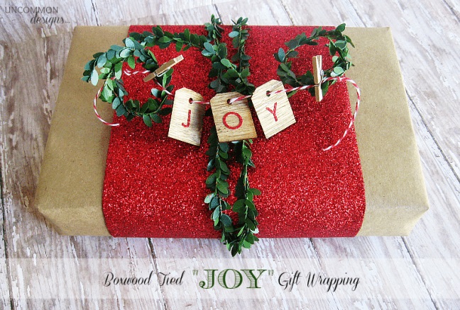 Boxwood wrapped with joy letters.