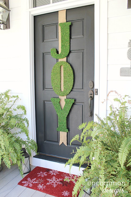 DIY moss joy sign for door decor.