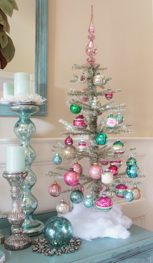 Dashing silver tinsel tree decorated with colored balls.