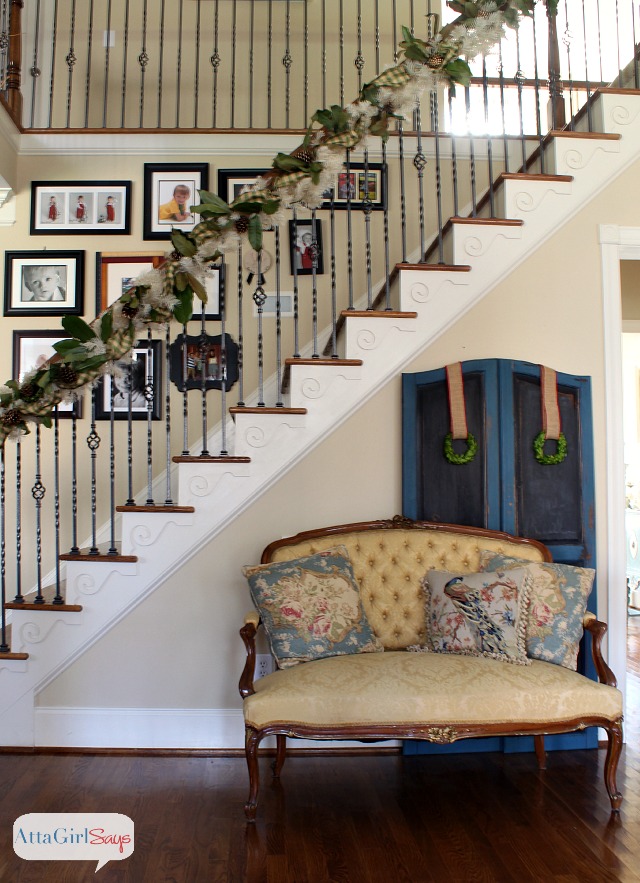 Handmade magnolia & gilded pinecone Christmas garland for staircase.