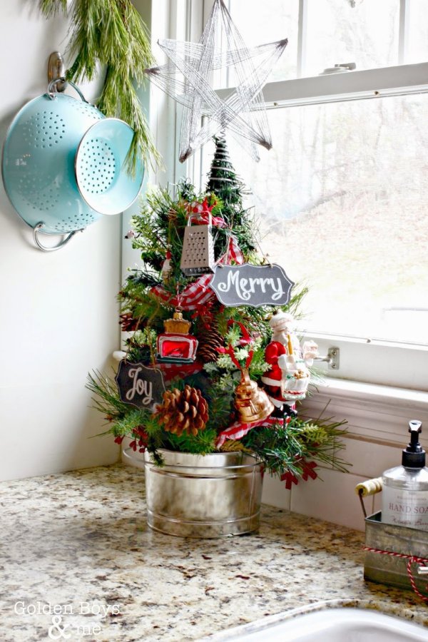 Mini Christmas tree for kitchen decorated with cheese grater and toaster ornament.