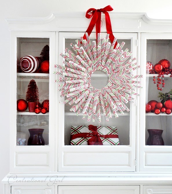 Wrapping paper wreath with beautiful red ornaments for decoration.