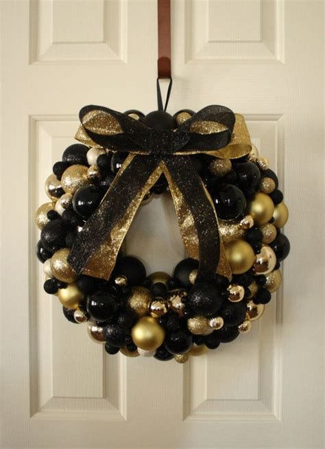 Black and golden ornament wreath for door decor.