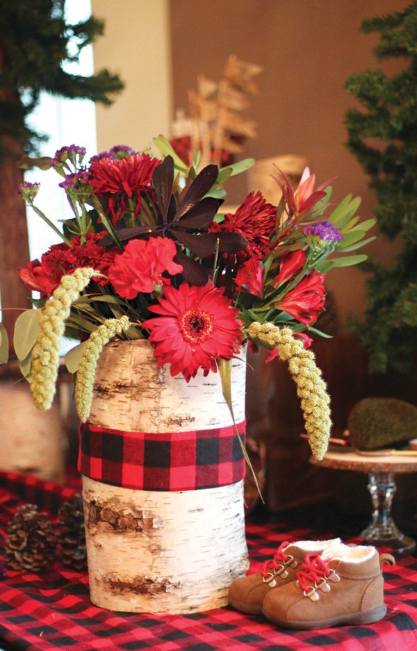Flower vase with matching plaid table cover.