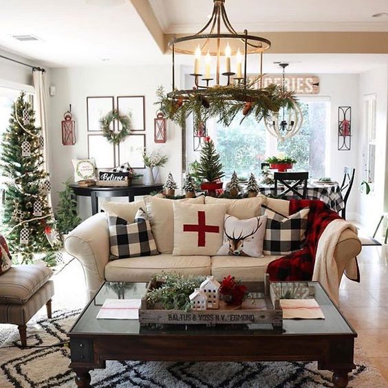 Garland on chandelier, tree, wreath, rustic centerpiece and pillows, everything is perfect for living room decor.
