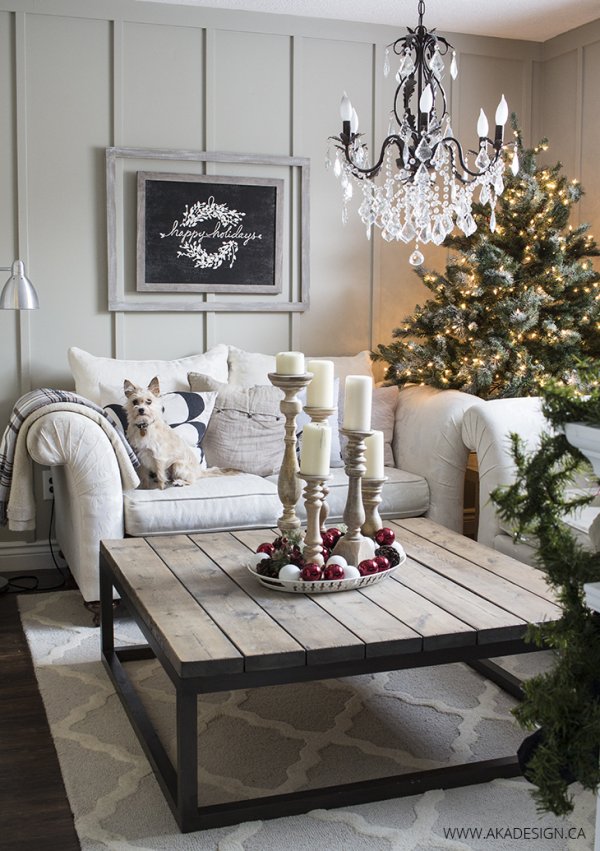Impressive living room decor with beautiful chandelier, Christmas tree and wooden sign board.