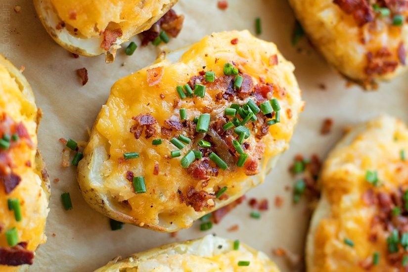 Loaded twice baked potatoes stuffed with bacon, cheese and topped with fresh chives.