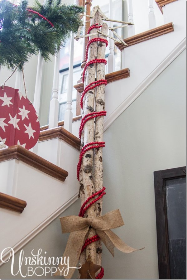 Logs got wrapped in faux-cranberry garland like a giant candy cane.