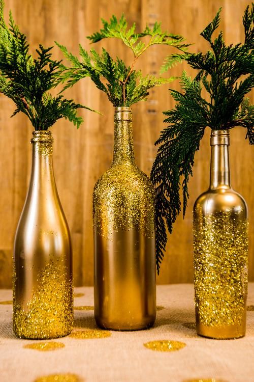 Lovely glittered wine bottles as flower vase.