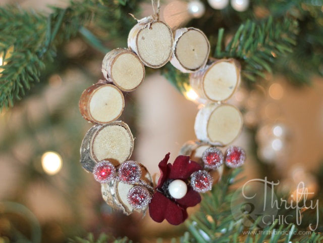 Mini woodland wreath ornament decorated with flower and berries.