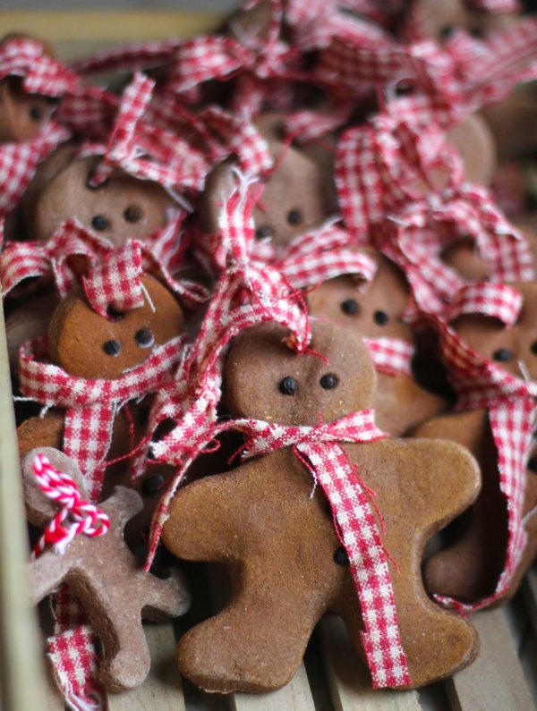Nice gingerbread man with peppercorn kernels for eyes and gingham ribbon for scarves.