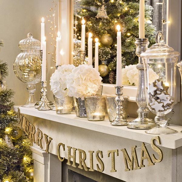 Silver, gold and white mantel decor with golden Merry Christmas garland.