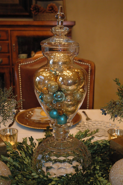 Simple glass candy jar filled with golden balls turns into a gorgeous Christmas table centerpiece.