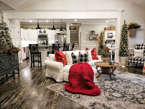 Skinny Christmas trees, beige sofa with awesome Christmas theme pillows perfect for living room.