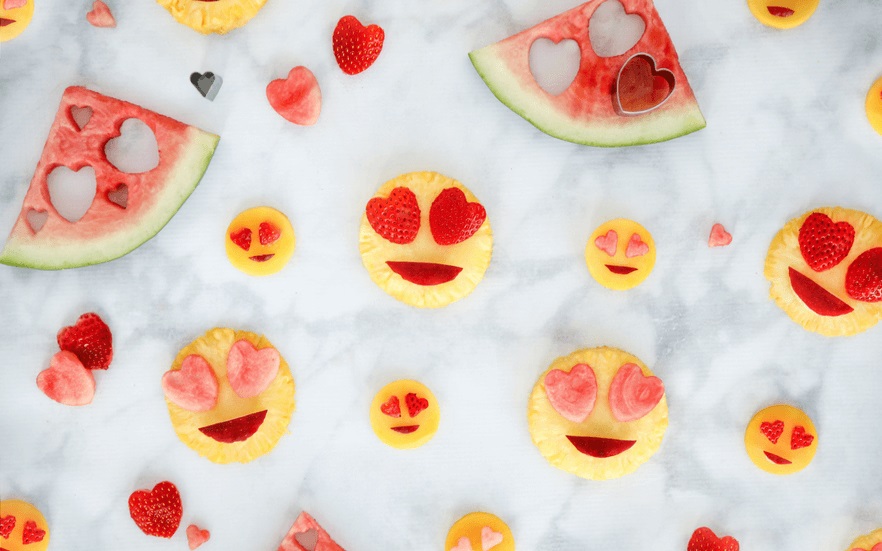 Emoji fruit salad with heart eyes.