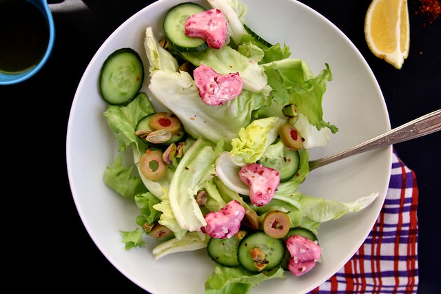 Green salad with pink goat cheese hearts.