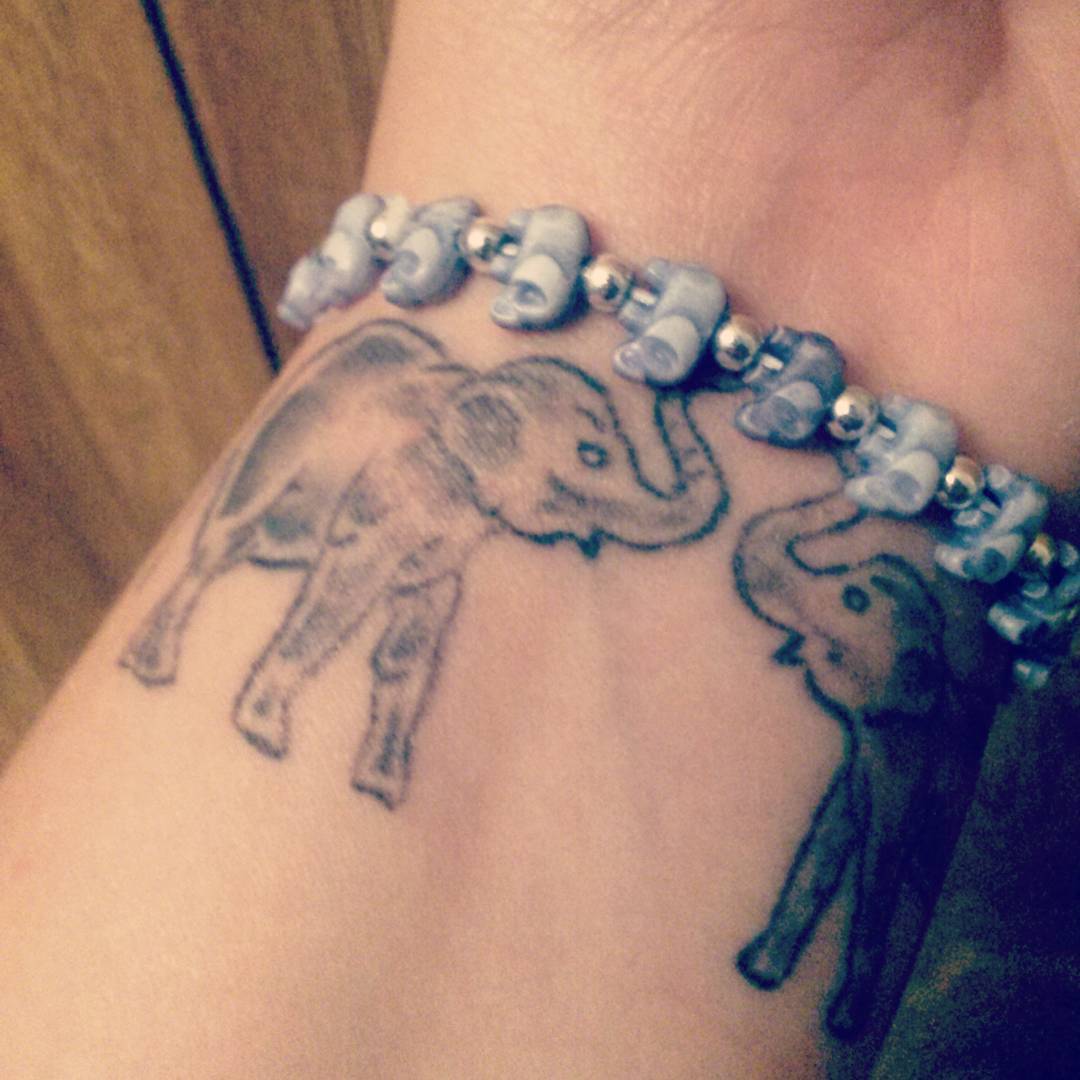 Awesome elephants on wrist.
