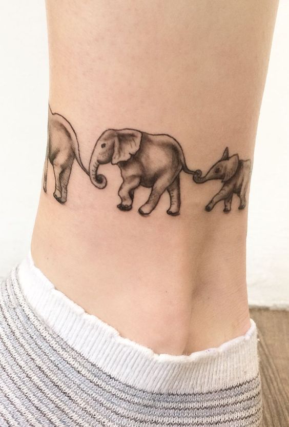 Beautiful family of elephant tattoo on ankle.