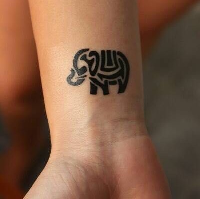 Bold black line elephant tattoo on wrist.